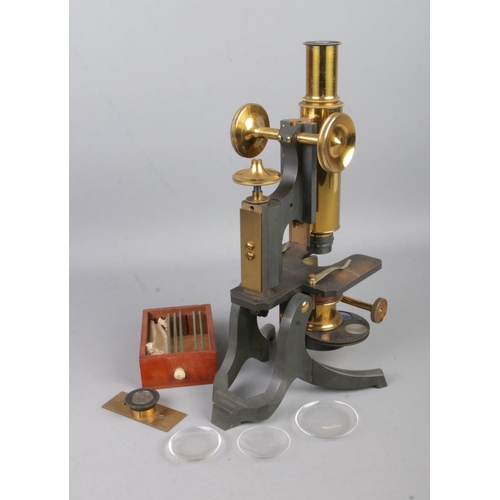 1 - A mahogany cased Negretti & Zambra brass bodied microscope, with adjustable column, lenses and slide... 