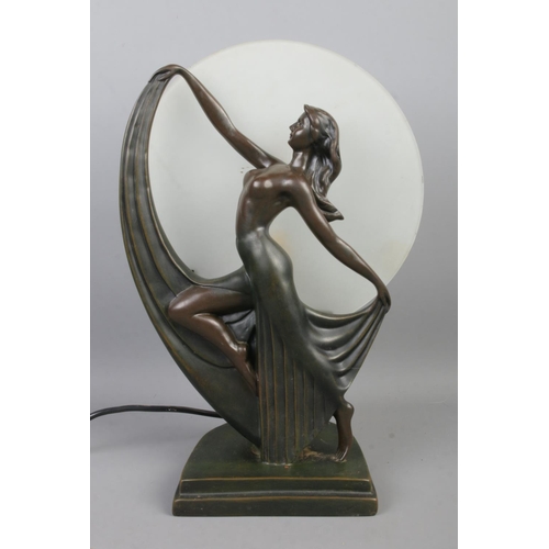 114 - An Art Deco inspired Widdop Bingham Co. bronzed table lamp formed as a dancing lady posed in front o... 