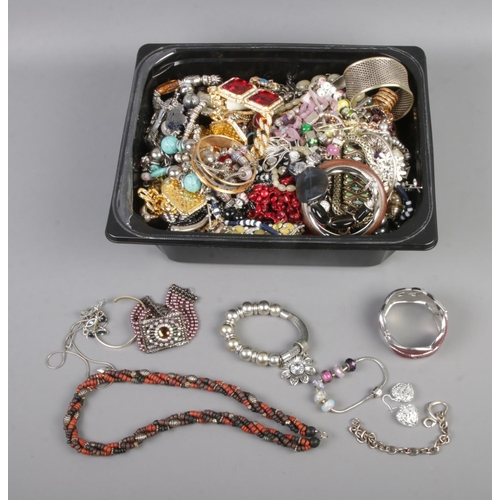 136 - A large tub of assorted costume jewellery to include bracelets, bangles, rings, earrings, etc. Also ... 