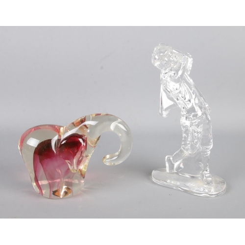 22 - A Waterford crystal figure formed as a golfer alongside a Shudehill art glass figure formed as an el... 