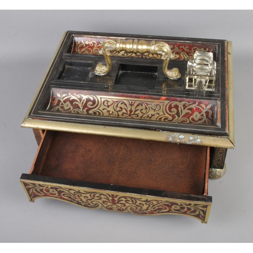 3 - A Boulle work and brass desk tidy featuring single hidden drawer.