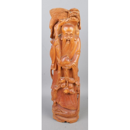 39 - A carved Chinese figure depicting a man surrounding by various animals including pair of dragons, to... 