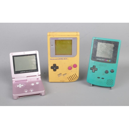 44 - A 1989 Nintendo Game Boy, with Dr. Mario game cartridge and two later Game Boy consoles; Color and A... 