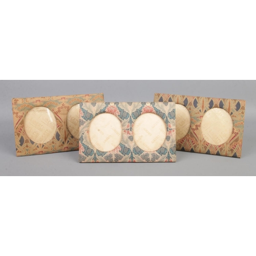 46 - Three Liberty of London dual oval fabric photo frames, on easel back. Bears gold stamps to the back.... 