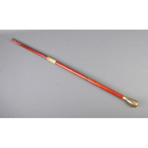 76 - A three part drinking/tipple cane featuring hidden glass drinking tube and screw top vessel within p... 