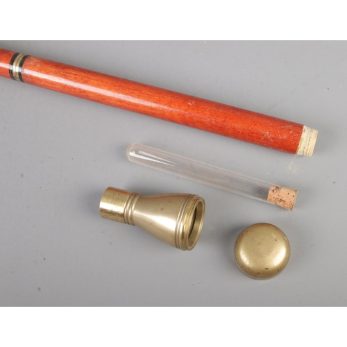 76 - A three part drinking/tipple cane featuring hidden glass drinking tube and screw top vessel within p... 