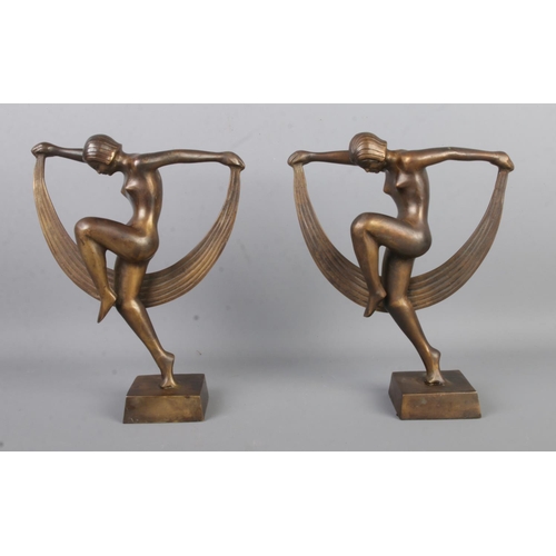 458 - A pair of Art Deco style bronze female dancers, both holding scarves, raised on square bases. Height... 