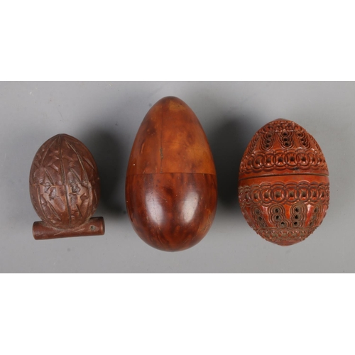 466 - Three collectable pieces of treen, consisting of a carved coquilla nut formed as an egg, tagua nut t... 