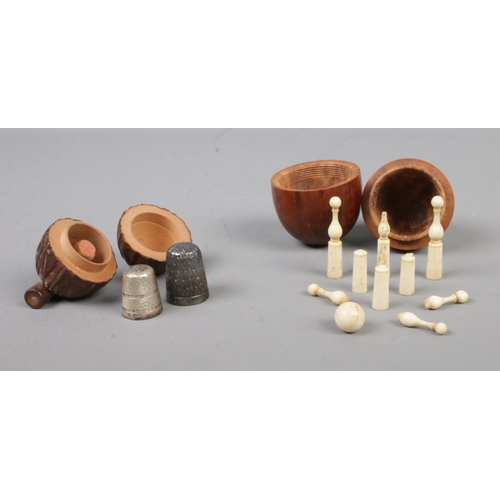 466 - Three collectable pieces of treen, consisting of a carved coquilla nut formed as an egg, tagua nut t... 