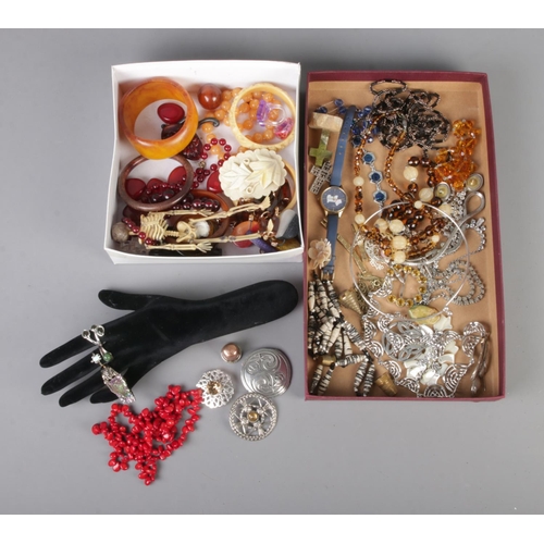 87 - Two trays of assorted costume jewellery to include dress rings on hand display, bangles, necklaces e... 