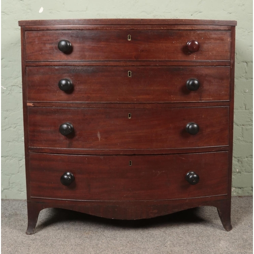 517 - An early Victorian mahogany bow fronted chest of four drawers, featuring turned handles, raised on s... 