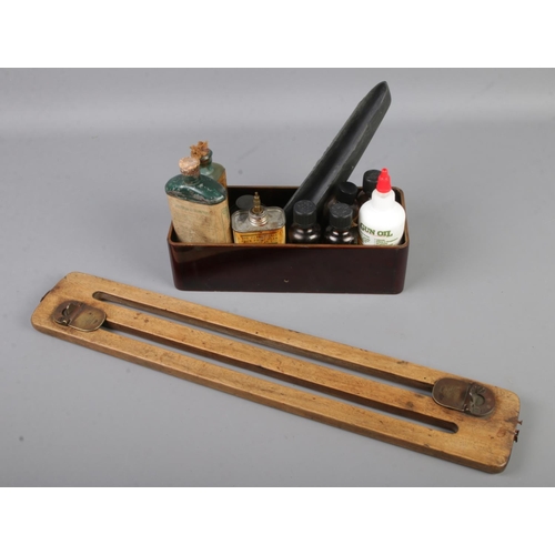 103 - An antique game carrier by James Dixon & Sons together with various gun keeping oils