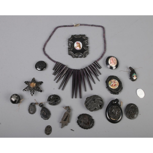 104 - A tray of jet and similar jewellery including brooches and necklaces etc