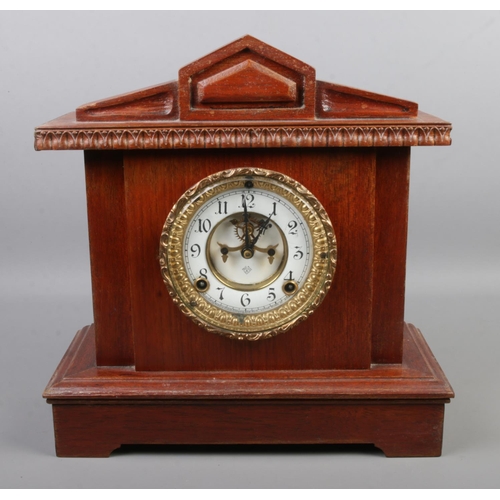 125 - An Ansonia oak cased mantel clock.