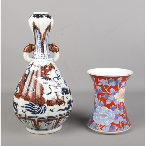 13 - Two Chinese vases including a garlic head shape dragon vase along with a blue and red waisted vase.