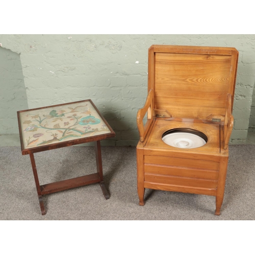 504 - An antique commode together with an embroided screen/fold over table