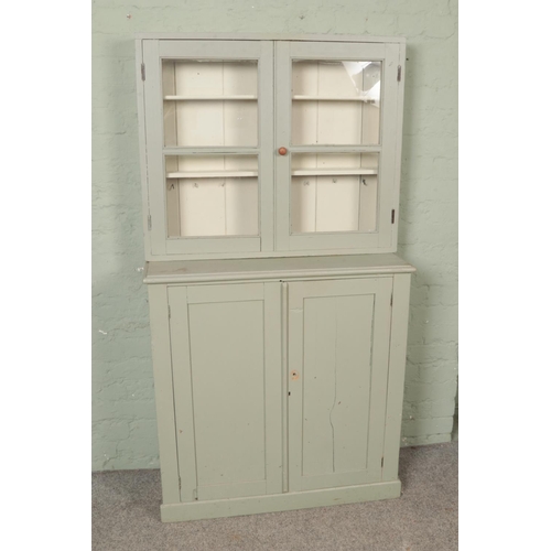 525 - A painted pine cupboard and wall hanging glazed cabinet