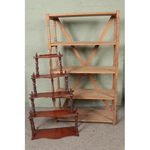 534 - A pine open back bookcase with turned supports together with a whatnot stand.