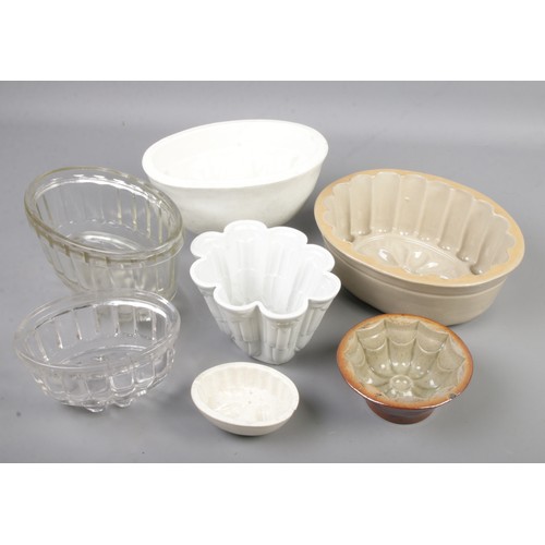 8 - A collection of jelly moulds including glass and stoneware examples.