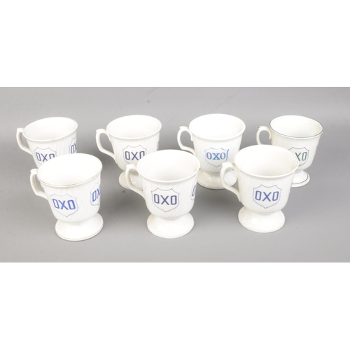 114 - A collection of seven vintage ceramic OXO advertising mugs.