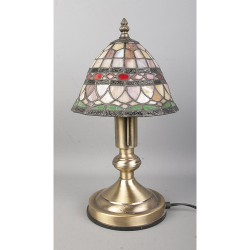 19 - A Tiffany style table lamp, on stepped circular base. Height: 37cm.