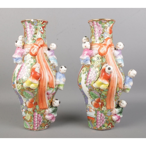 28 - A pair of Chinese 'Fertility' vases, decorated in bright colours and gilt highlights, with applied c... 