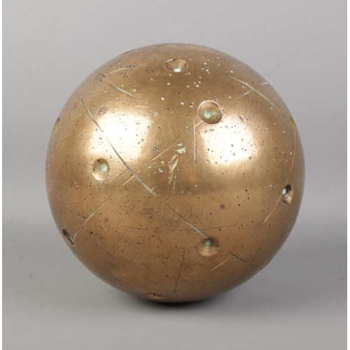 38 - An unusual bronze sphere, with small circular indentations across the body. Possibly linked to astro... 