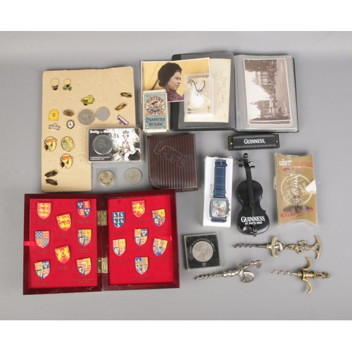 42 - A quantity of collectables to include British coins, Guinness harmonica, complete set of Kings and Q... 