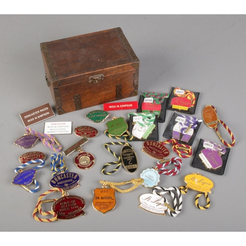 49 - A small oak box with contents of Doncaster Racecourse badges, including staff and members examples.