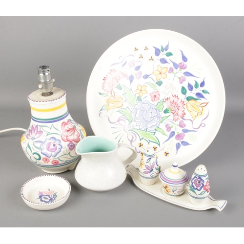 50 - A collection of Poole ceramics. Includes charger (diameter 31.5cm), cruet set, table lamp etc.