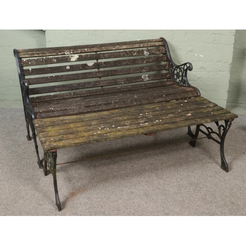 316 - A wood and iron garden bench along with low table.