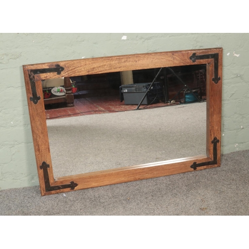 332 - A modern rustic style wall mirror featuring metal brackets to corners. Approx. dimensions 92cm x 61c... 