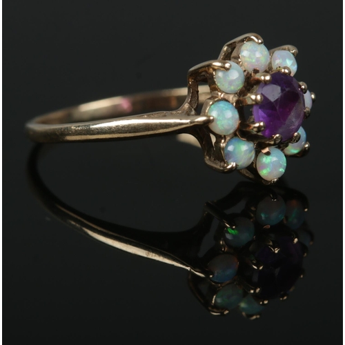 341 - A 9ct gold opal and amethyst cluster ring, Size M½. Total weight: 1.6g.