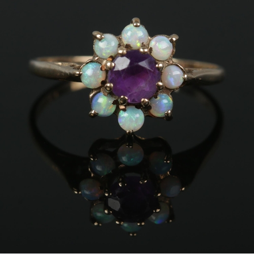 341 - A 9ct gold opal and amethyst cluster ring, Size M½. Total weight: 1.6g.