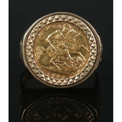 343 - A 9ct Gold mounted half sovereign ring, with pierced shoulders. Size W. Total weight: 9.3g. Stamped ... 