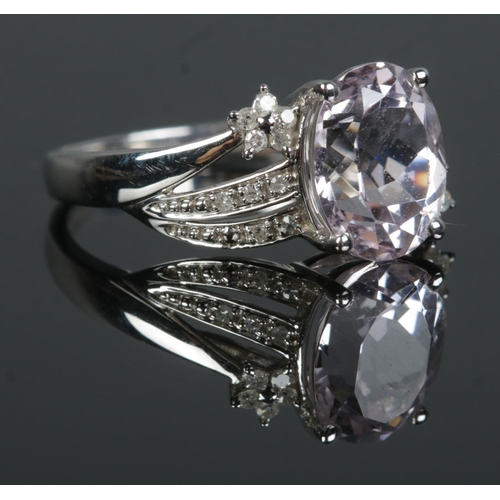 355 - A 9ct White Gold Kunzite and Diamond ring, with large central faceted stone surrounded by Diamond sh... 