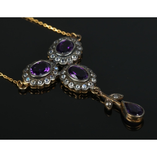 359 - An Art Nouveau style Lavalier droplet pendant, set with moonstone and amethyst coloured stones, on g... 