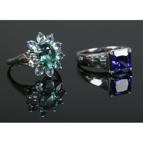 366 - Two silver dress rings; one set with blue topaz stones. Sizes N and N½. Total weight: 7.5g