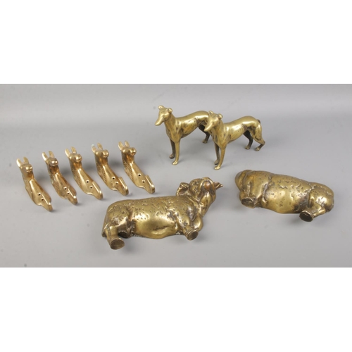 7 - A small collection of brasswares, to include horse head hooks, greyhounds and cow.