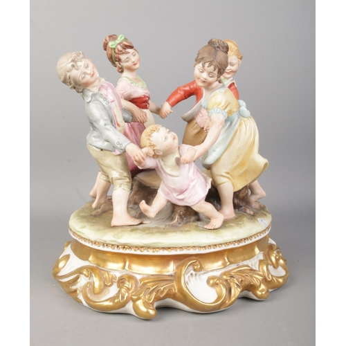 2 - A Capodimonte figure group 'Ring A Roses' depicting children in a circle surrounding a tree trunk. R... 