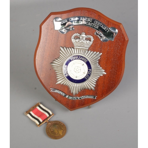 381 - A George V Special Constabulary Long Service Medal, 1951 along with a South Yorkshire Police plaque.... 