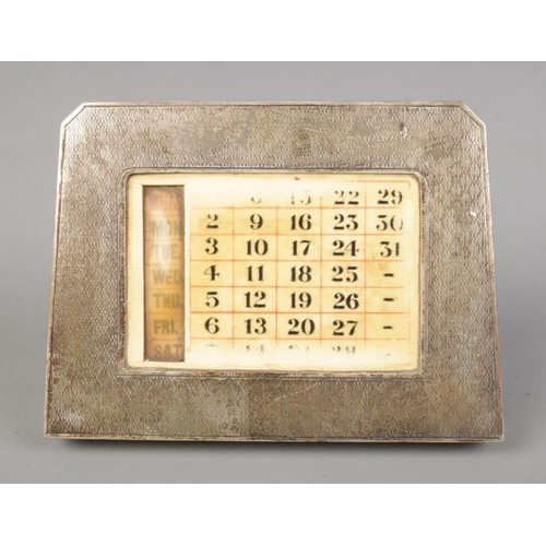 393 - A silver perpetual day, date desktop calendar assayed Birmingham 1929.