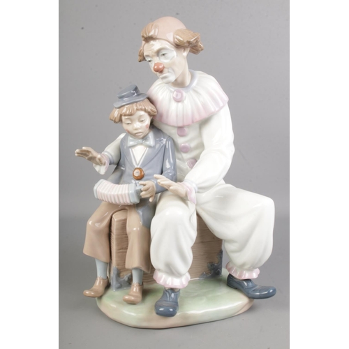 406 - A large Nao by Lladro 'Lesson of Music' No 701 figure, designed by Vicente Martinez of a clown teach... 