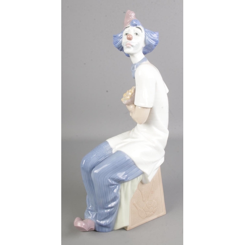 407 - A large Nao by Lladro of a seated clown with flowers