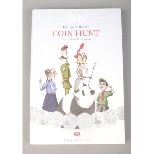 412 - The Royal Mint; A Coin Hunt 50p collection folder featuring circulated coins, alongside a cased circ... 