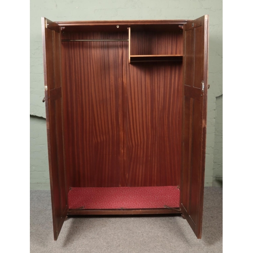 451 - A Butilux oak double wardrobe along with matching chest of six drawers. Both having linen fold decor... 