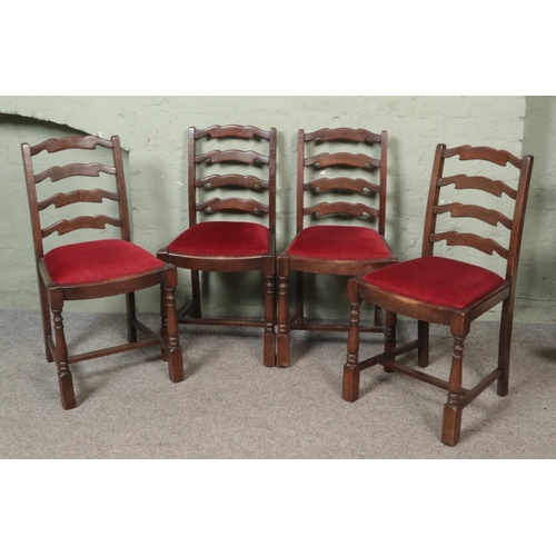 458 - A set of four oak ladder back dining chairs.