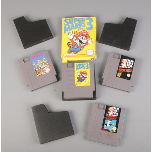 86 - Four Nintendo Entertainment System (NES) Mario related cartridges; Super Mario Bros. , Super Mario 3... 