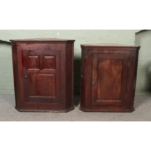 470 - Two oak panelled corner cupboards each having single cupboard door