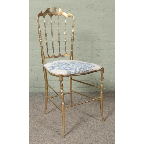 482 - An Italian brass Chiavari chair, with shaped and spindle back rest on turned supports.